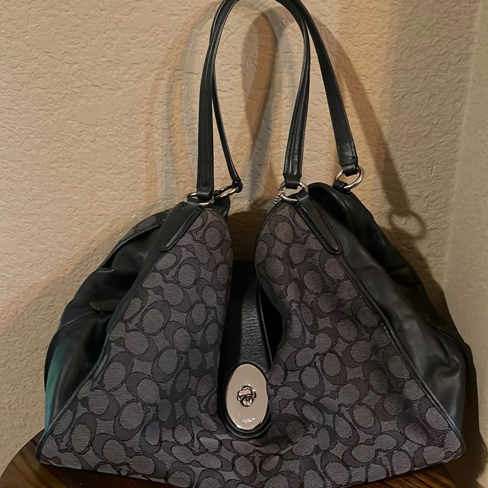Black and gray coach matching shoulder purse and wallet with silver accent.